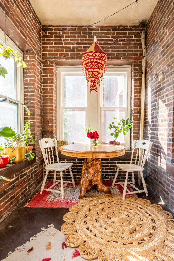 Exposed brick sunroom with dining nook area