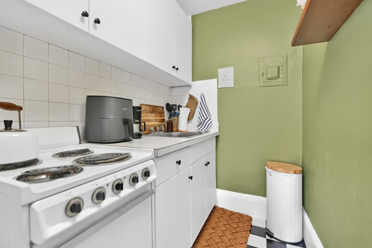 Green painted kitchen after renovation.