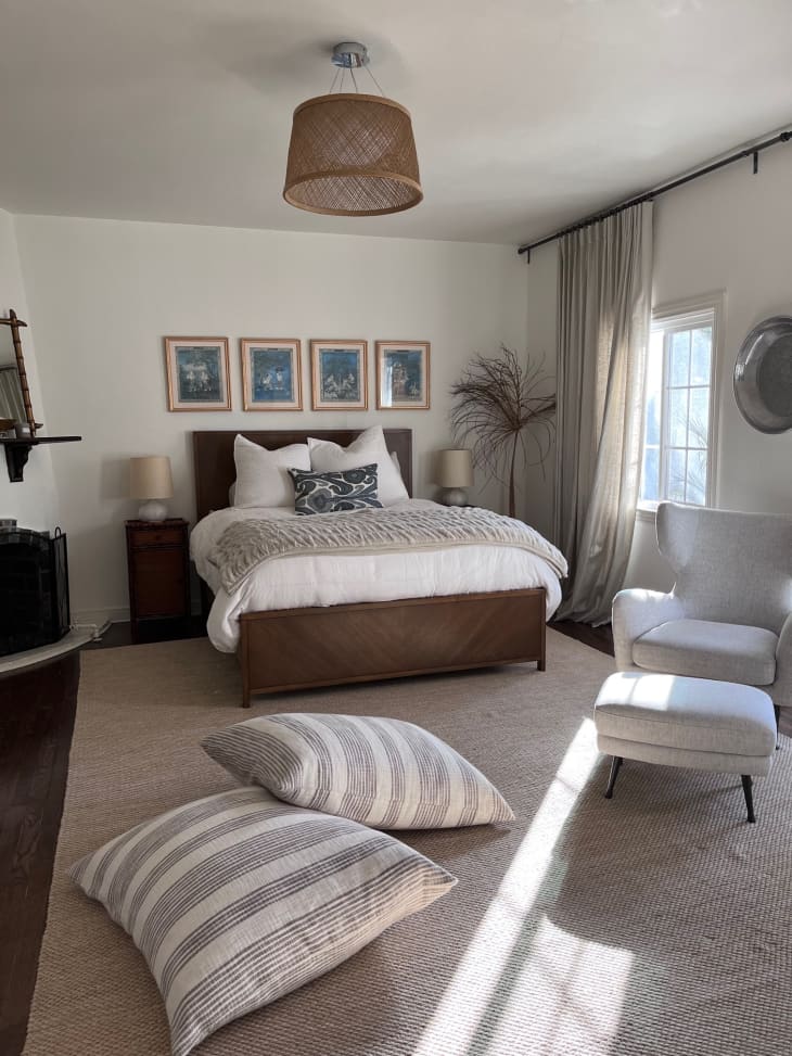A white bedroom with large pillows on the floor