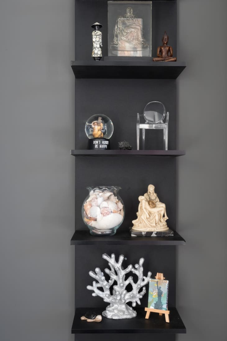Detail of black shelves with l'objets