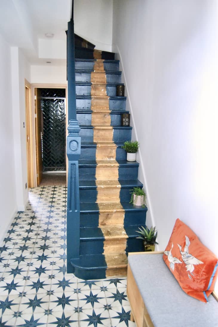 Blue entryway with star motif tiles and painted stairs.