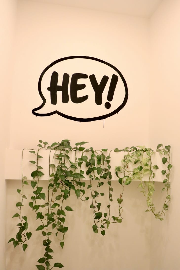 A speech bubble painted on a wall reading "HEY!".