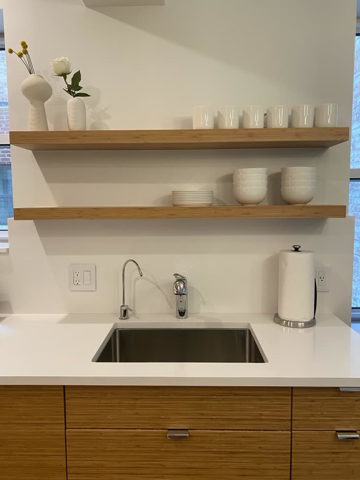 Two wooden shelves above the kitchen sink