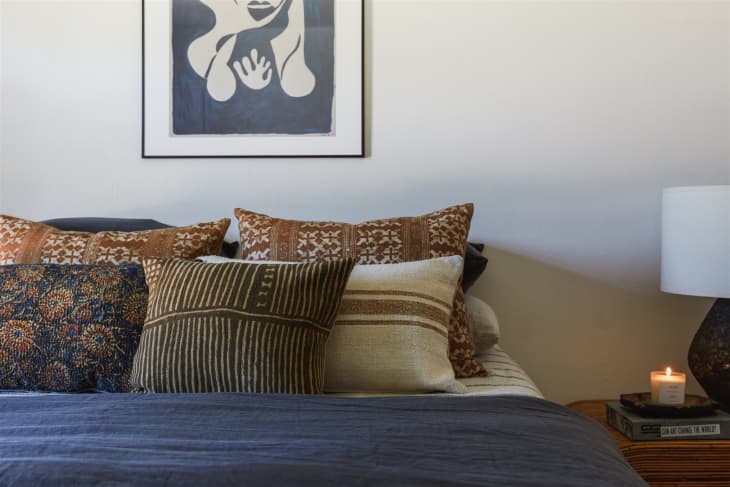 Decorative pillows arranged on neatly made bed.