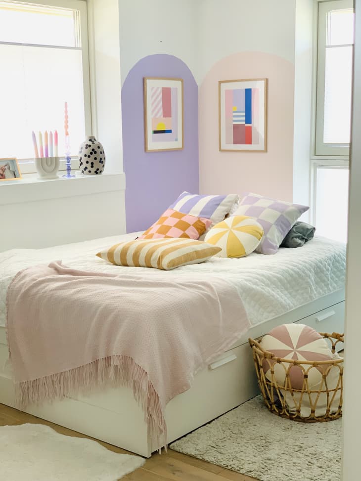 pink and purple color block mural, wood floor, neutral rugs, pastel pink throw, accent pillows, natural light