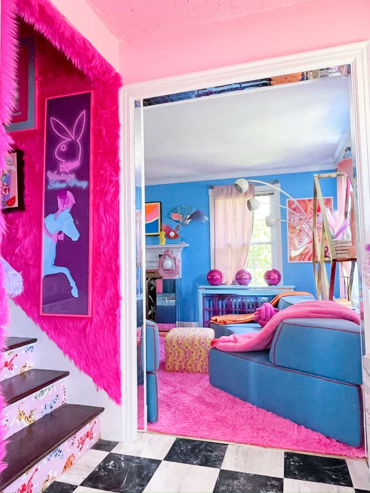 entry, stairs, pink, playboy bunny, black and white checkered floor, doorway, blue couch, pink carpet, blue walls, pink disco balls, vintage floor lamp