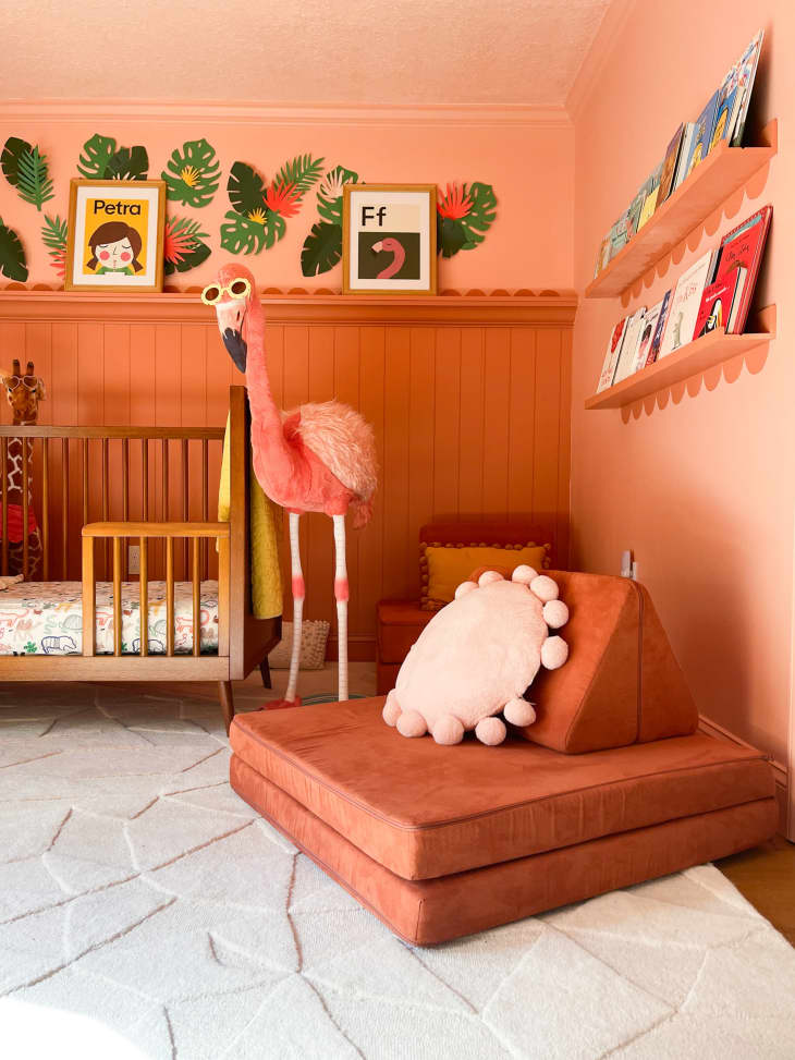 A orange padded cushion
 chair in a nursery.