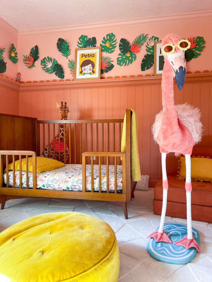 A larger flamingo in a light orange painted nursery.