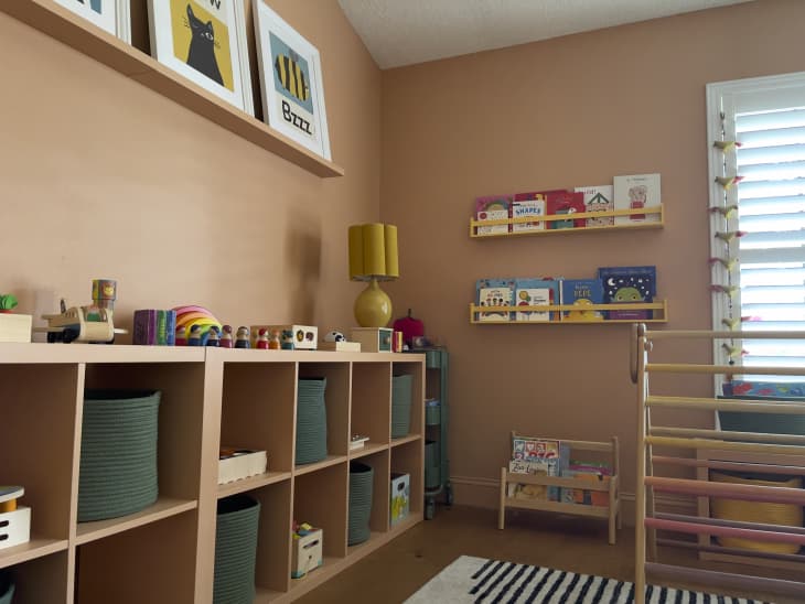 A playroom with light brown walls and organized cubbies.