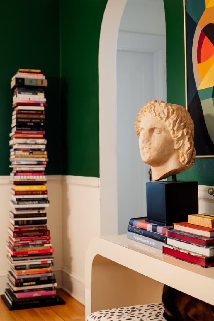 detail of shelf with bust/head, abstract painting on wall, stacked books