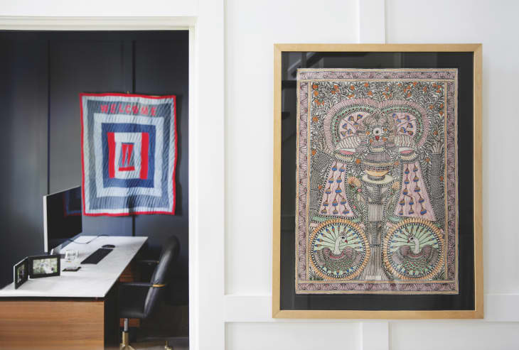 Art on white wall, photo of office with quilt on wall, wood, wood cut or illustration of peacocks in wood frame