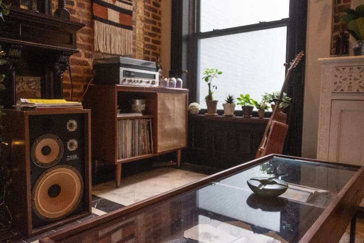 brooklyn brownstone parlor-floor apartment music-listening area with exposed brick, lots of wood, record player, guitar, cozy details