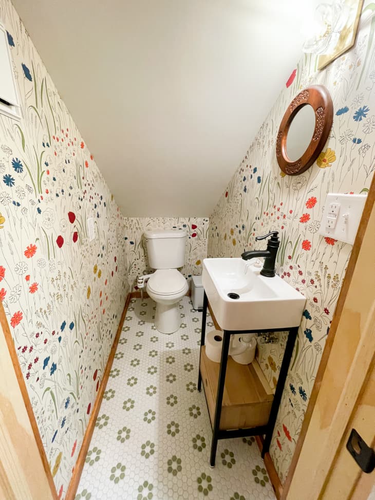 Narrow bathroom with angled ceiling, floral wallpaper