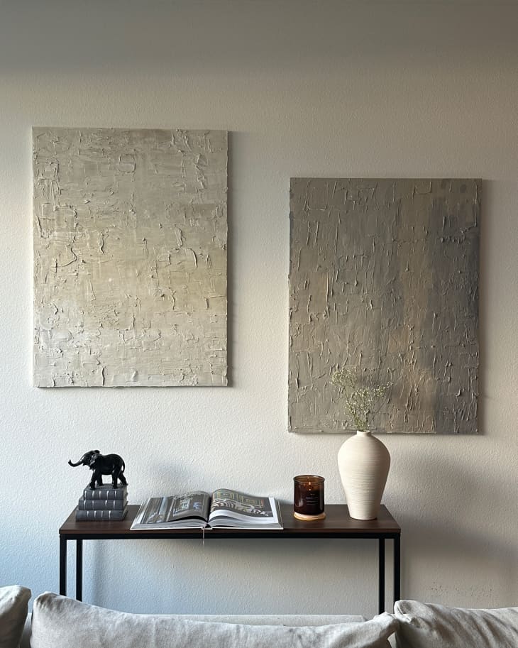 Minimalist artwork hung on wall in living room.