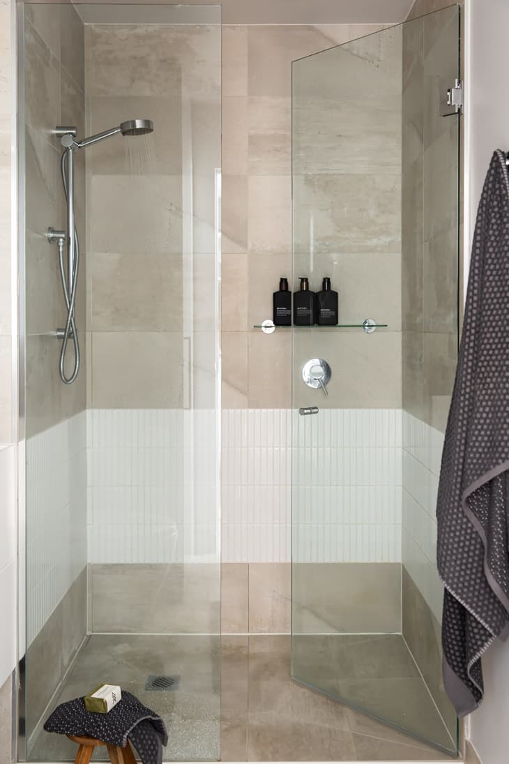 Neutral colored tile in glass shower.