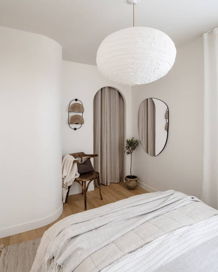 Apartment bedroom with lots of white, natural wood, natural colors, natural fiber textiles