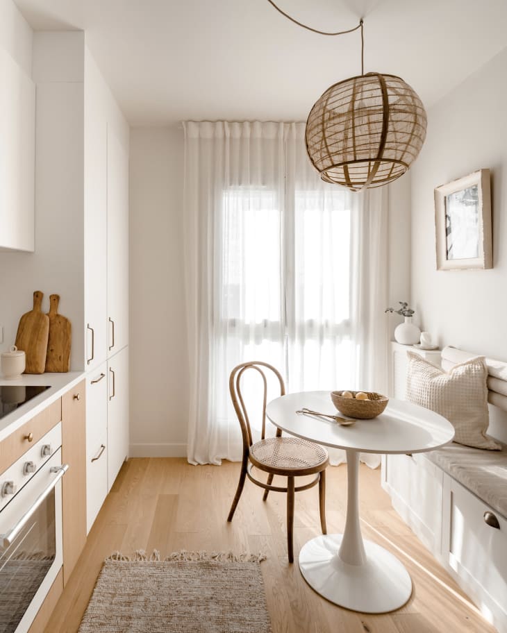 Apartment kitchen/dining room with lots of white, natural wood, natural colors, natural fiber textiles