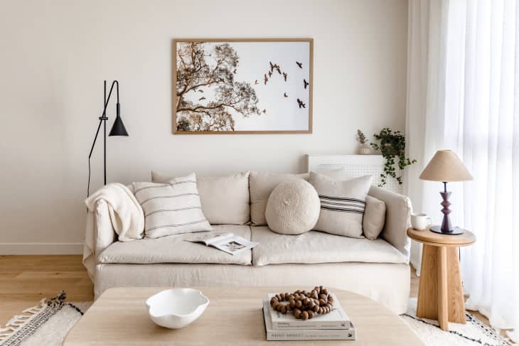 Apartment living room with lots of white, natural wood, natural colors, natural fiber textiles