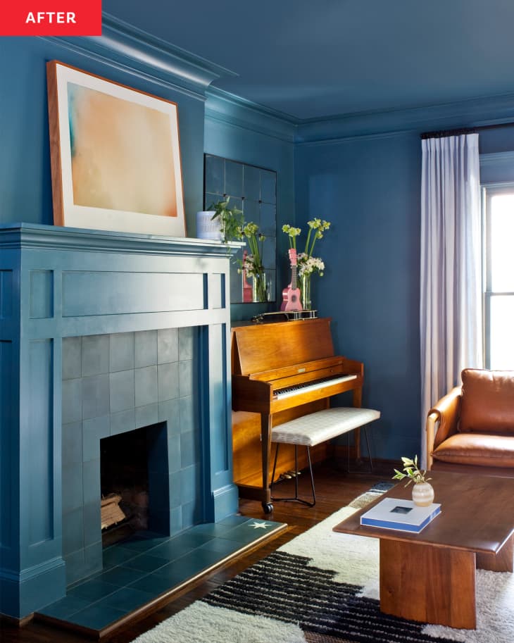 Living room after makeover with blue walls, white sofa, wood and warm-colored accents
