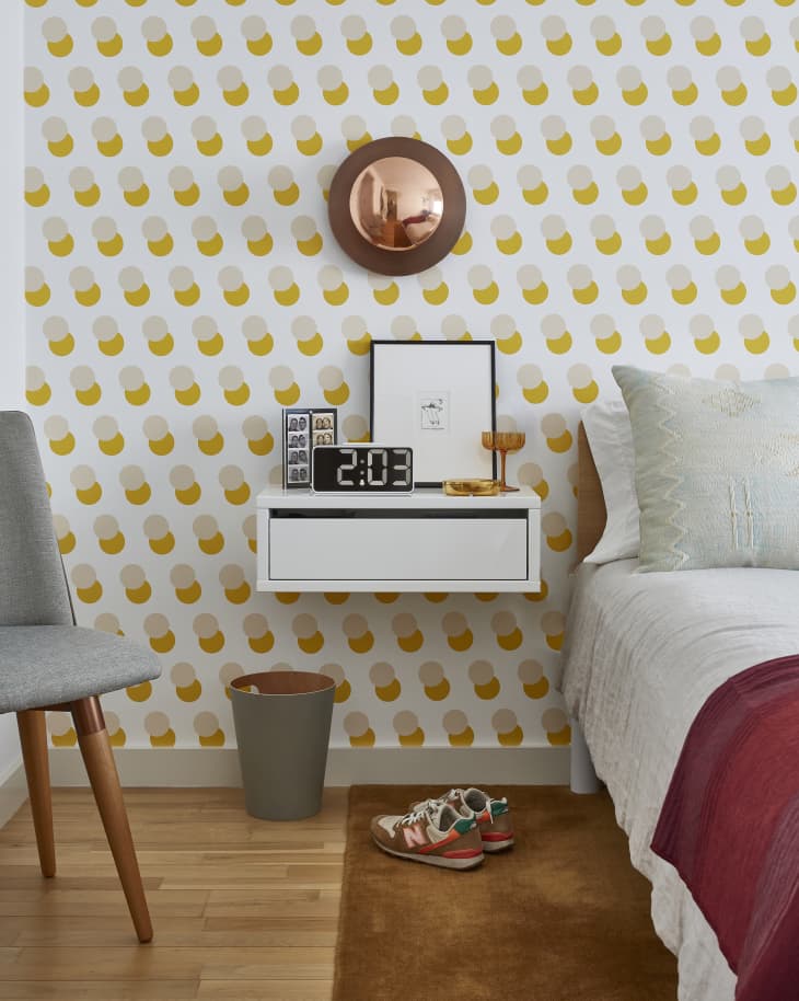 detail of bedroom with yellow circle wallpaper