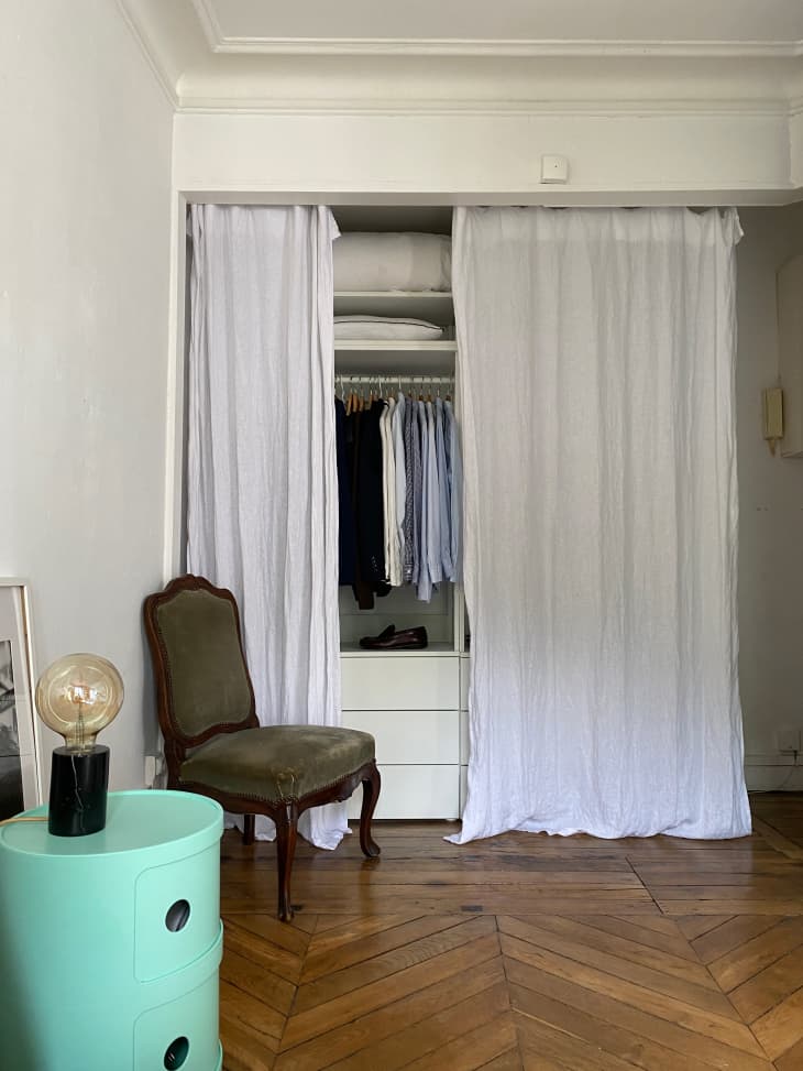 Drapes used to cover clothing in small Paris apartment.