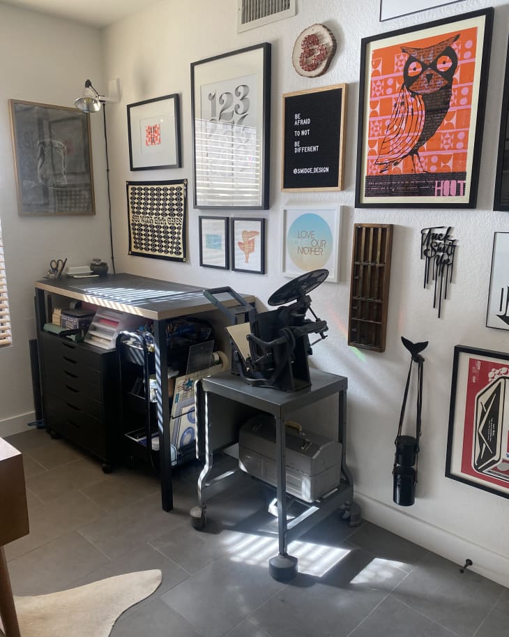home workspace area with gallery wall above