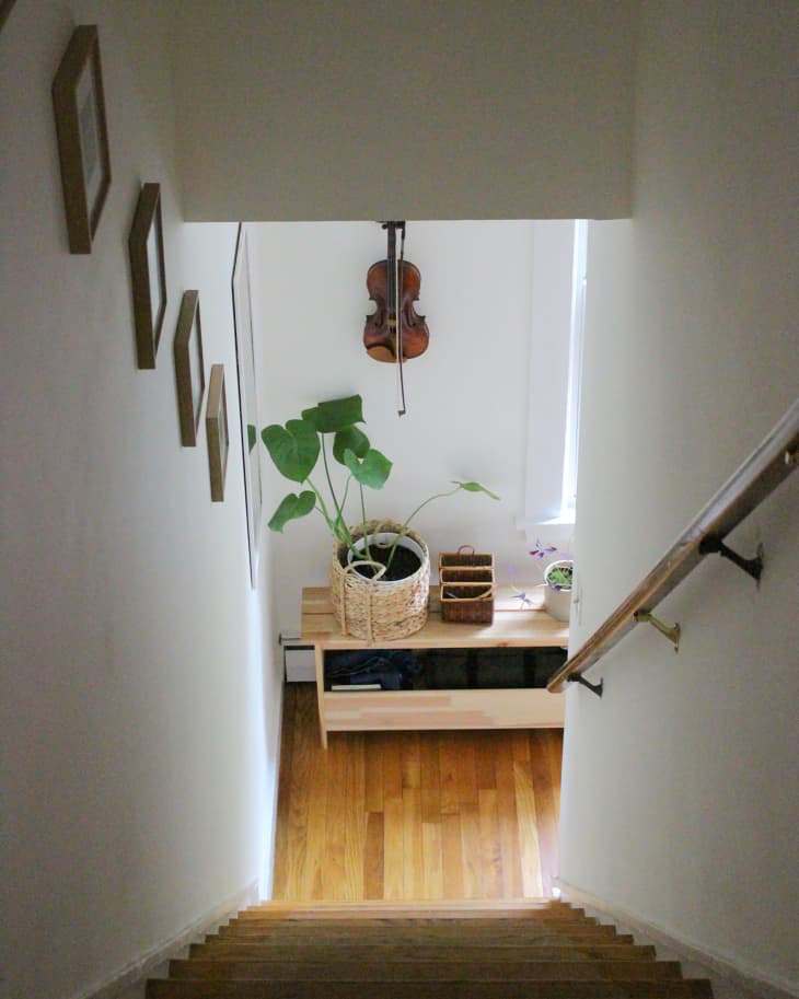 Violin mounted on wall at the bottom of stairs.