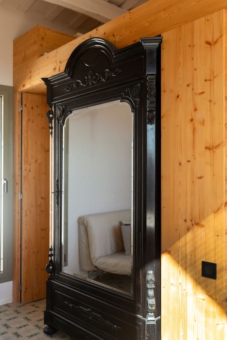 detail  of large black ornate door/window into living room