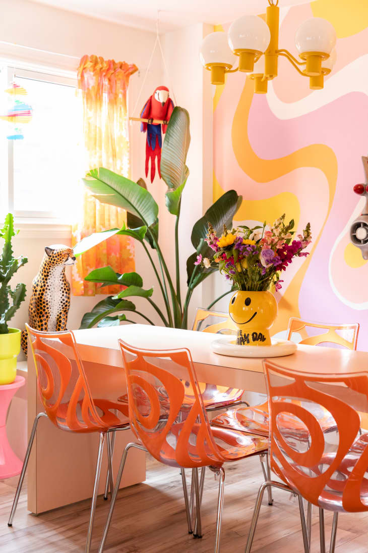Smiley face flower vase in colorful dining room.