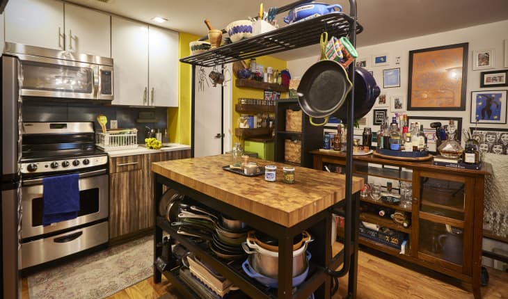 Cookware on kitchen island in small NYC kitchen.