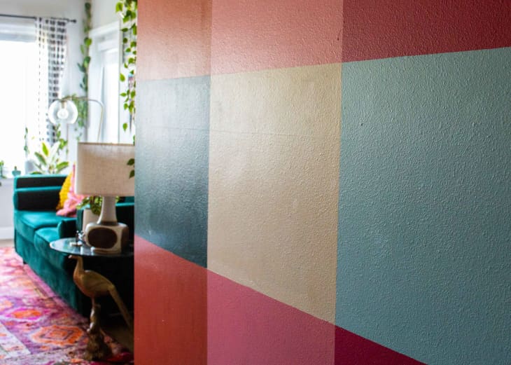 A wall decorated with grid of  various colors.