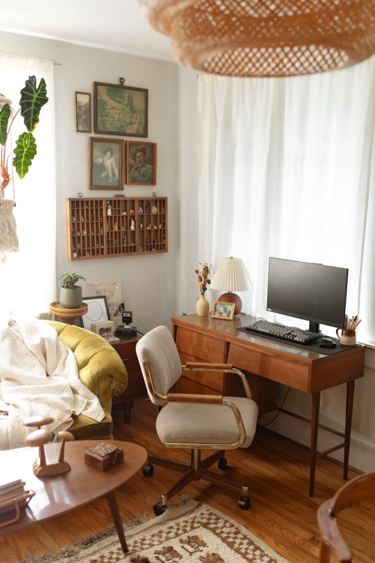 wood vintage desk and workspace in corner of white room