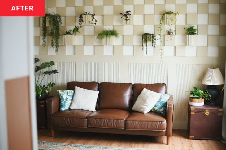 living room after renovation with brown leather sofa and relief checkered beige and white wall with built in plant pots
