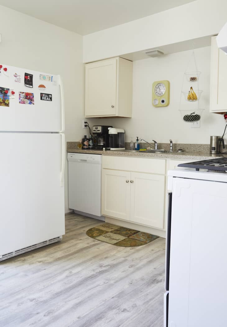 white small kitchen with pale gray wood finish floor and vintage wall clock