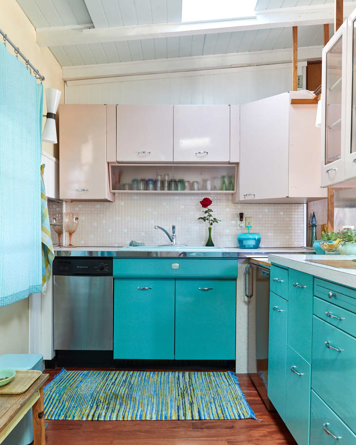 Blue and pink cabinets in mid century modern kitchen.