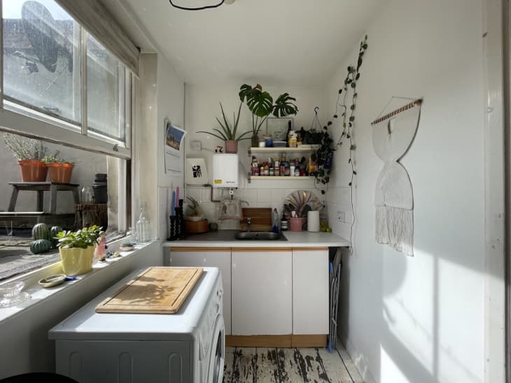 white kitchen with white cabinets and large window
