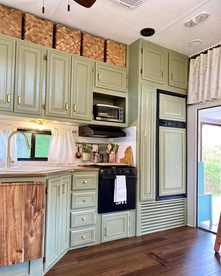 Green painted cabinets in RV kitchen.
