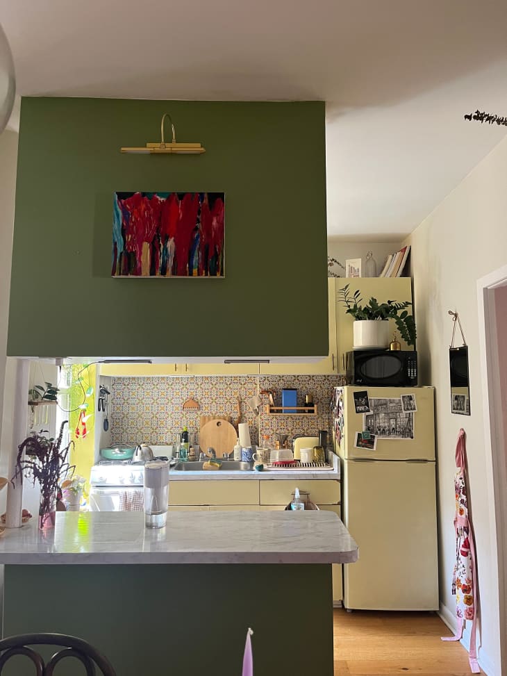 Green and yellow kitchen in New York city apartment.