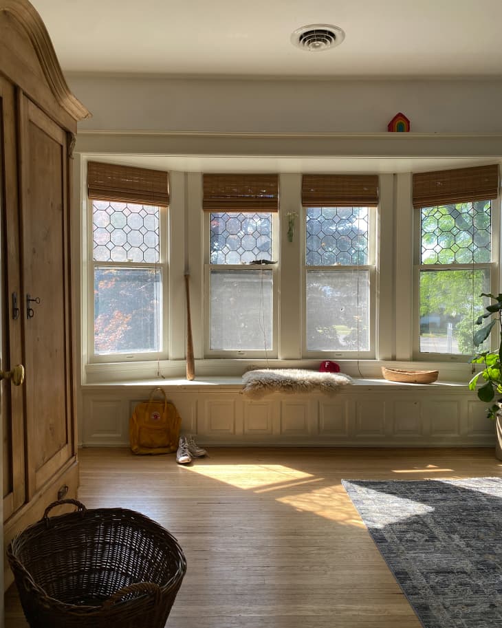Light streaming into bay windows with window seat.