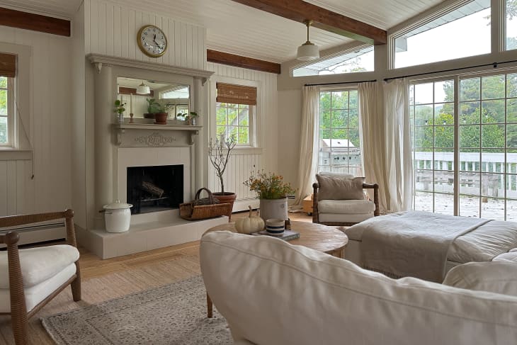 Neutral living room with large open windows and fireplace.