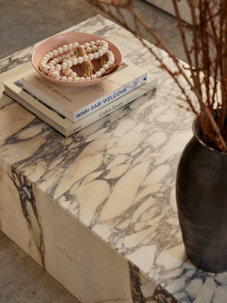 Decorative books on marble coffee table.