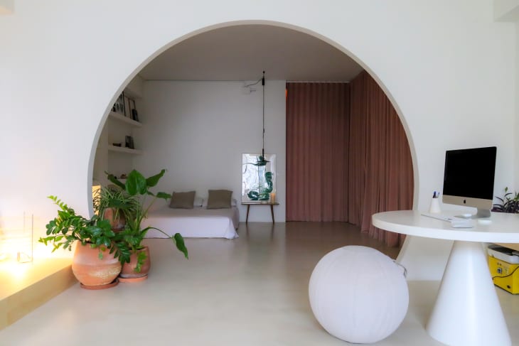 Arch looking into minimalist bedroom.