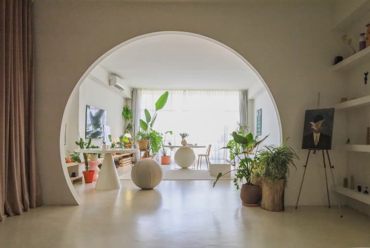 Arch looking into plant filled bedroom.