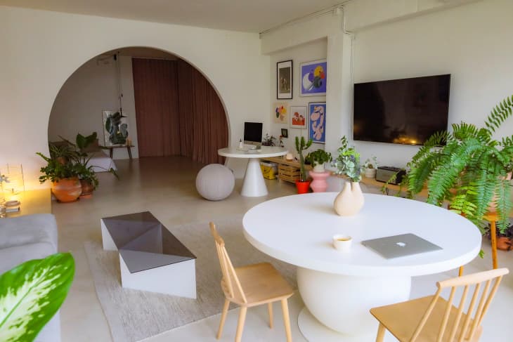 Round white dining table in studio apartment.