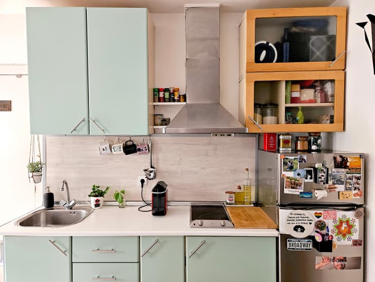 Green cabinets in small kitchen.
