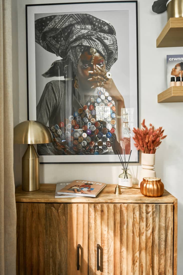 wood small cabinet with art above