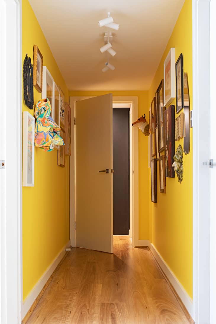 yellow hallways with lots of framed art