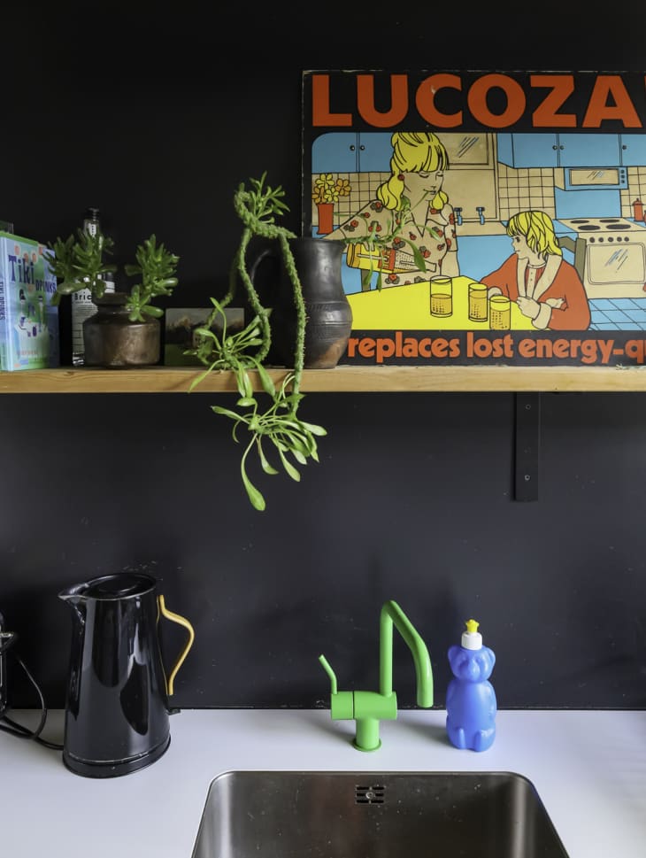 A green facet in a black painted kitchen.