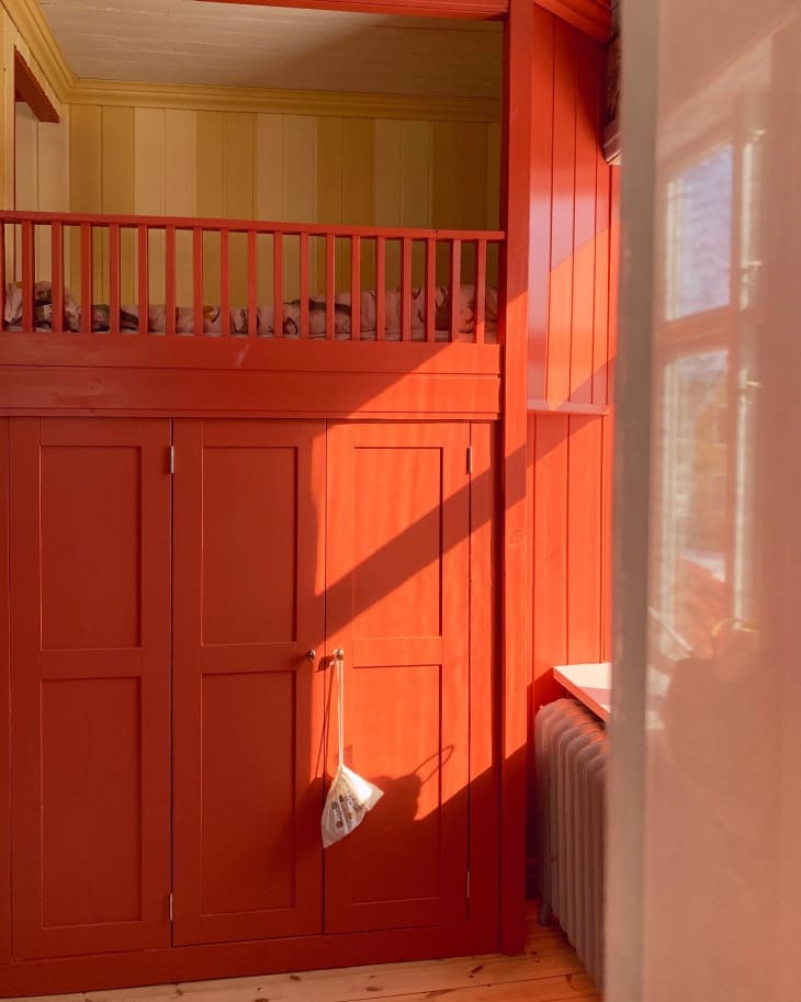 Detail of closet in coral and yellow kids bedroom with hideout bunk bed