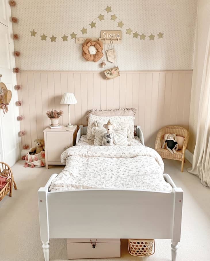 peach kids' room with white bed with storage underneath